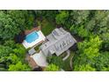 Stunning aerial view showcasing the estate's pool, lush greenery, and the home's architectural design at 131 Lavinia Ln, Chapel Hill, NC 27516
