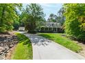 Attractive home featuring a long driveway, well-maintained lawn, and a welcoming front porch at 131 Lavinia Ln, Chapel Hill, NC 27516