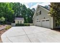 Spacious three-car garage with a driveway and additional storage shed perfect for tools and equipment at 131 Lavinia Ln, Chapel Hill, NC 27516