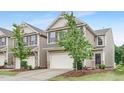 View of a home with a two-car garage and neutral-toned siding at 133 Explorer Dr # 258, Morrisville, NC 27560