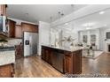 Open concept kitchen featuring granite countertops, a stainless steel refrigerator, and hardwood floors at 133 Explorer Dr # 258, Morrisville, NC 27560