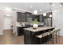 Modern kitchen featuring a center island, granite countertops, stainless steel appliances, and dark cabinetry at 133 Explorer Dr # 258, Morrisville, NC 27560