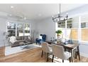 Sunlit living and dining area featuring hardwood floors and modern chandelier at 1514 W Knox St, Durham, NC 27705