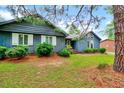 Beautiful blue home with large windows, white trim, and a lush green lawn at 1732 Farmington Rd, Rocky Mount, NC 27801
