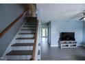 Cozy living room with staircase, gray floors, and contemporary decor at 1806 Stroll Cir, Fuquay Varina, NC 27526