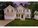 Charming two-story home with a well-manicured lawn, blue shutters, and a welcoming front porch at 201 Forbes Rd, Wake Forest, NC 27587