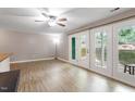 Inviting living room with hardwood floors, fan and sliding door to exterior space at 2010 Quaker Lndg # 102, Raleigh, NC 27603
