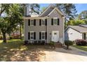 Two story home featuring black shutters, white trim, and manicured front yard at 203 Kronos Lane, Cary, NC 27513