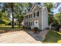 A well-maintained home with a manicured lawn, driveway, and side yard at 203 Kronos Lane, Cary, NC 27513