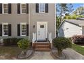 Classic home front entrance with sidelights, fresh paint and manicured bushes at 203 Kronos Lane, Cary, NC 27513