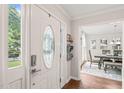 Inviting foyer with decorative glass front door and view into a dining room at 21 Cedar Hill Dr, Durham, NC 27713