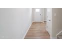 Bright hallway featuring light wood floors and white trim leading to other rooms at 2106 Cherry Creek Road Rd, Haw River, NC 27258