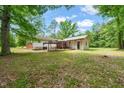 Expansive backyard featuring a covered patio area, ideal for outdoor entertaining and relaxation at 211 Cool Spring Rd, Durham, NC 27713
