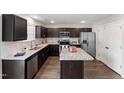 Modern kitchen with dark cabinets, stainless steel appliances, granite countertops and island at 218 Mason Rd, Durham, NC 27712