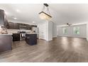 Open-concept living space with wood floors, connecting the kitchen, dining, and living areas at 218 Mason Rd, Durham, NC 27712