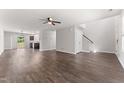 Bright living area with hardwood floors, neutral paint, ceiling fan and access to the backyard at 218 Mason Rd, Durham, NC 27712