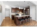 Kitchen featuring a large island with seating, granite countertops, and stylish pendant lighting at 222 Explorer Dr # 271, Morrisville, NC 27560
