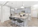 Modern kitchen featuring gray cabinets, granite countertops, stainless steel appliances, and a central island with bar seating at 222 Explorer Dr # 271, Morrisville, NC 27560