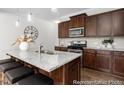 Kitchen showcasing a granite island with seating and modern stainless steel appliances at 222 Explorer Dr # 271, Morrisville, NC 27560