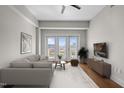 Bright living room features a comfortable couch, modern decor, and a balcony with city views at 222 Glenwood Ave # 714, Raleigh, NC 27603