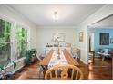 Bright dining room featuring hardwood floors, a large window, and a spacious dining table set at 24 Sunrise Pl, Durham, NC 27705