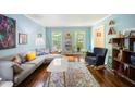 Bright living room with hardwood floors, comfortable seating, a large window and stylish decor at 24 Sunrise Pl, Durham, NC 27705