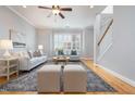Inviting living room with hardwood floors, a ceiling fan, and neutral decor for a comfortable atmosphere at 2609 Stewart Pines Dr, Raleigh, NC 27615