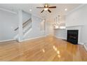 Sun-drenched living room boasts hardwood floors, a cozy fireplace, and staircase to the second level at 2609 Stewart Pines Dr, Raleigh, NC 27615