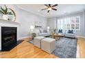 Bright living room featuring a fireplace, large windows, and stylish decor creating a welcoming space at 2609 Stewart Pines Dr, Raleigh, NC 27615