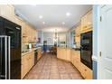 Spacious kitchen featuring tile floors, light cabinets, and stainless-steel appliances at 3 Bent Oak Ct, Durham, NC 27705