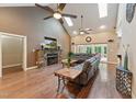 Bright living room boasts vaulted ceilings, skylights, stone fireplace, and hardwood floors at 31 River View Ct, Timberlake, NC 27583