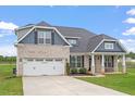 Charming single-Gathering home with a well-manicured lawn and attached two-car garage at 337 Brinkley Cir, Mebane, NC 27302