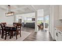 Open-concept dining area and living room featuring hardwood floors and coffered ceilings at 337 Brinkley Cir, Mebane, NC 27302
