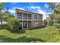 Backyard view showcasing a screened porch, manicured lawn, and the home's back exterior with a walkout basement at 3400 Secretariat Way, Raleigh, NC 27614