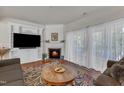 Cozy living room with hardwood floors, fireplace, and large windows at 3400 Secretariat Way, Raleigh, NC 27614