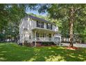 Beautiful two-story home featuring a cozy front porch and well-maintained landscaping at 353 Spearhead Pl, Clayton, NC 27520