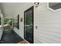 Close-up of front door with decorative accents, welcoming porch and fresh paint at 353 Spearhead Pl, Clayton, NC 27520