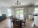 Open dining area with sliding glass doors to the deck and a view of the backyard at 3927 Wedonia Dr, Cary, NC 27519