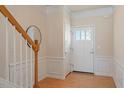 Welcoming foyer with hardwood floors, wainscoting, and decorative front door at 401 Dyersville Dr, Morrisville, NC 27560