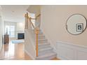 Carpeted staircase with wooden banister leading to the upper level at 401 Dyersville Dr, Morrisville, NC 27560