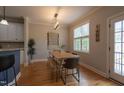 Bright dining area with a wooden table and bench seating adjacent to the kitchen at 441 Heritage Village Ln, Apex, NC 27502
