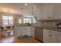 Well-equipped kitchen featuring granite countertops, stainless steel appliances and white cabinets at 441 Heritage Village Ln, Apex, NC 27502