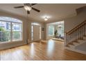 Bright living room featuring hardwood floors, large windows, and an open layout at 441 Heritage Village Ln, Apex, NC 27502