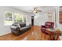 Bright living room with hardwood floors, a large window, and comfortable seating at 4906 Lakemont Dr, Raleigh, NC 27609