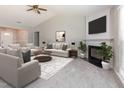 Inviting living room with vaulted ceiling, fireplace, and ample seating creating a cozy atmosphere at 503 Kinship Ln, Apex, NC 27502