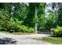 View of the property showing mature trees and a long driveway at 5213 Tomahawk Trl, Raleigh, NC 27610