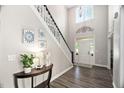 Grand entryway with soaring ceilings, elegant chandelier, staircase, and beautiful dark wood floors at 60 Morning Mist Dr, Garner, NC 27529