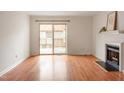 Bright living room with wood floors, fireplace, and sliding door access to the outdoor space at 6540 English Oaks Dr, Raleigh, NC 27615