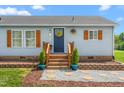 Inviting front porch with lovely plants and a decorative wreath enhancing the entryway appeal at 724 Harolds Northfield Dr, Cedar Grove, NC 27231