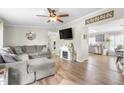Cozy living room with modern flooring, a large sectional sofa, and a decorative fireplace at 724 Harolds Northfield Dr, Cedar Grove, NC 27231
